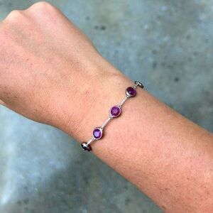 Adjustable silver bracelet with amethyst colored glass stones